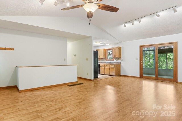 58 Oak Ter, Arden, NC 28704 - unfurnished living room featuring track lighting, lofted ceiling, light wood finished floors, and ceiling fan