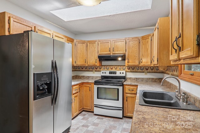 58 Oak Ter, Arden, NC 28704 - kitchen with appliances with stainless steel finishes, under cabinet range hood, light countertops, and a skylight