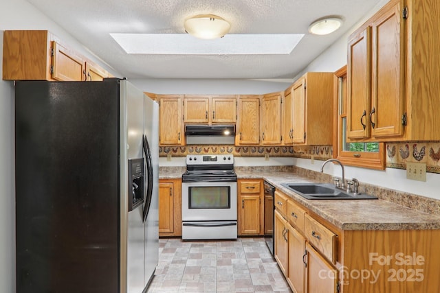 58 Oak Ter, Arden, NC 28704 - kitchen featuring appliances with stainless steel finishes, a skylight, ventilation hood, light countertops, and a textured ceiling