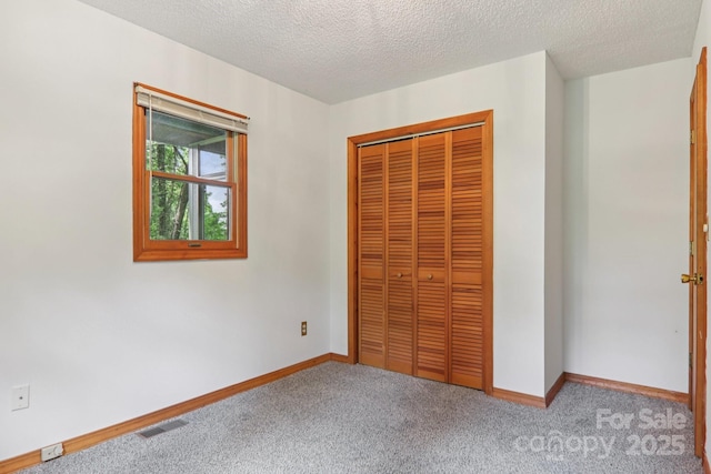 58 Oak Ter, Arden, NC 28704 - unfurnished bedroom with carpet flooring, a closet, and a textured ceiling