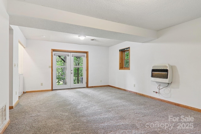 58 Oak Ter, Arden, NC 28704 - spare room featuring heating unit, carpet flooring, french doors, and a textured ceiling