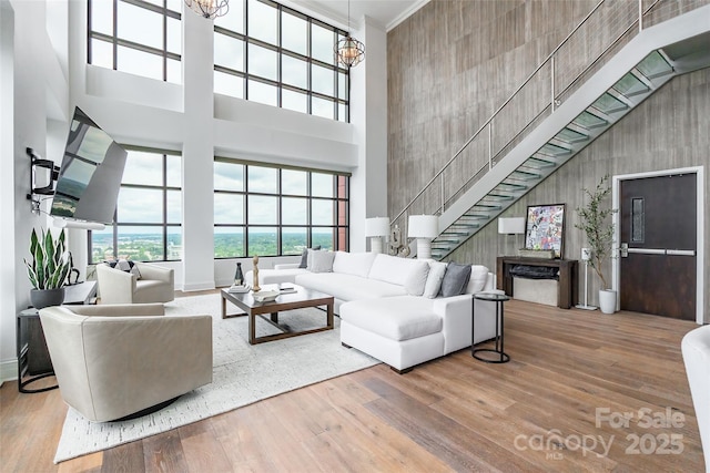 222 S Caldwell St # 2203, Charlotte, NC 28202 - living area featuring a high ceiling, wood finished floors, and stairs