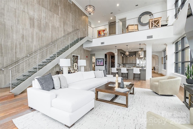 222 S Caldwell St # 2203, Charlotte, NC 28202 - living area with a towering ceiling, crown molding, stairway, light wood-style flooring, and recessed lighting