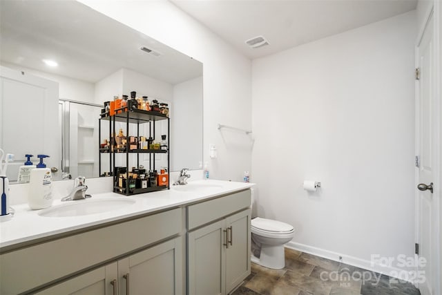 1343 Kent Downs Ave SW, Concord, NC 28027 - bathroom with double vanity, stone finish flooring, and a shower with door