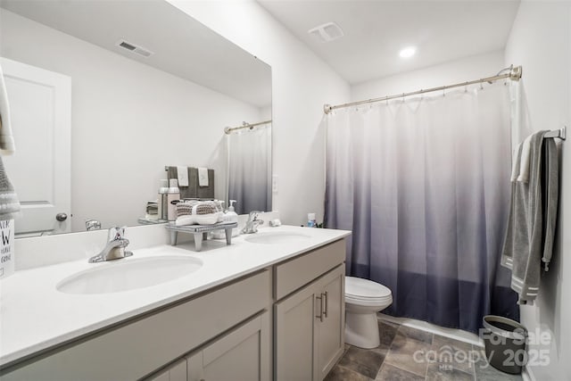 1343 Kent Downs Ave SW, Concord, NC 28027 - full bath with double vanity, stone finish floors, and a shower with shower curtain