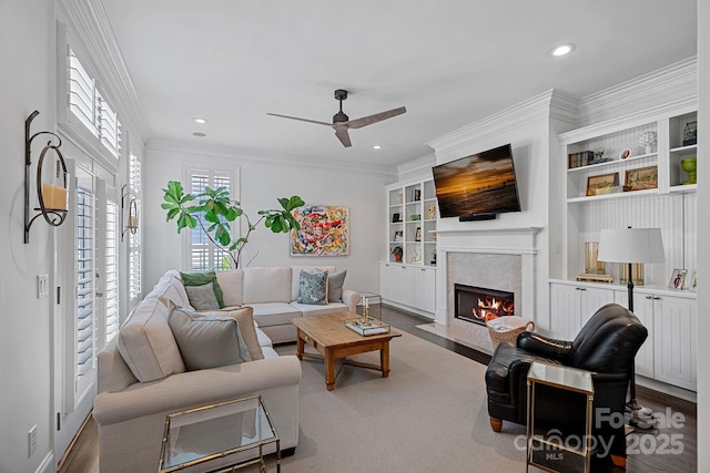 202 Caldwell Ln, Davidson, NC 28036 - living area featuring a ceiling fan, a fireplace with flush hearth, recessed lighting, ornamental molding, and built in features