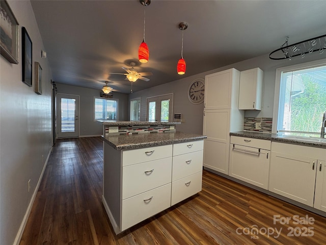 333 Mount View Ln Unit 266B, New London, NC 28127 - kitchen featuring dark wood-type flooring, a kitchen island, white cabinetry, decorative light fixtures, and ceiling fan