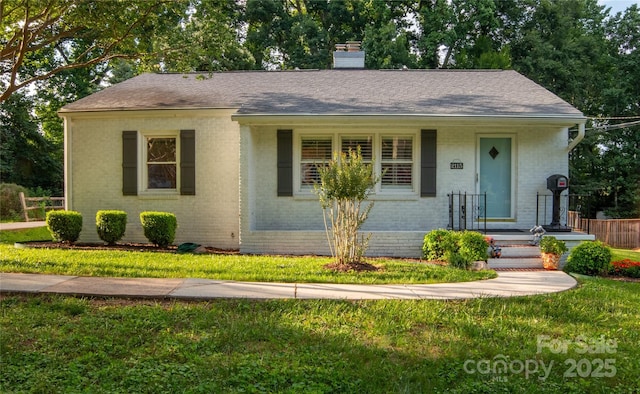 2115 Arnold Dr, Charlotte, NC 28205 - view of front of property featuring brick siding, a chimney, and a shingled roof