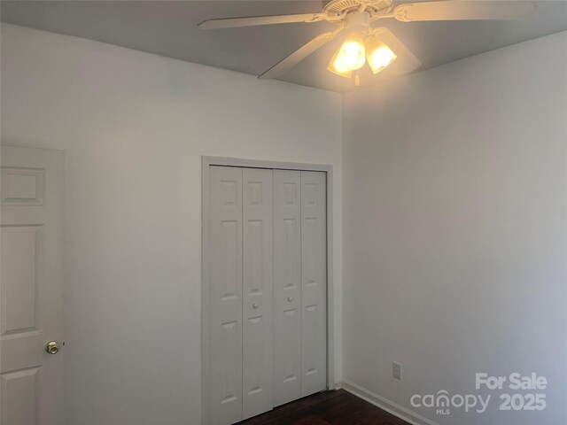 4454 Glenlea Commons Dr, Charlotte, NC 28216 - unfurnished bedroom with dark wood-type flooring, a closet, and ceiling fan