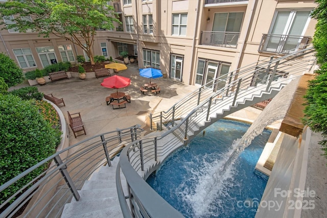 1315 E Blvd Unit 225, Charlotte, NC 28203 - view of swimming pool featuring stairs and a patio