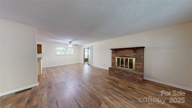 212 Fallen Timber Rd Unit 23, Hendersonville, NC 28791 - unfurnished living room featuring wood finished floors, ceiling fan, and a brick fireplace