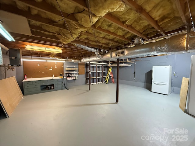 212 Fallen Timber Rd Unit 23, Hendersonville, NC 28791 - unfinished basement featuring freestanding refrigerator and a workshop area