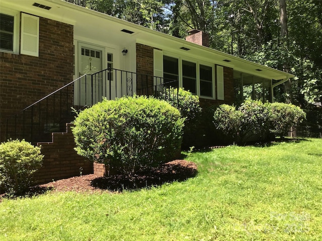 212 Fallen Timber Rd Unit 23, Hendersonville, NC 28791 - view of side of home with a chimney, brick siding, a yard, and an attached garage