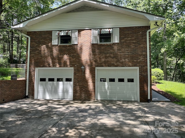 212 Fallen Timber Rd Unit 23, Hendersonville, NC 28791 - view of home's exterior featuring an attached garage, driveway, and brick siding