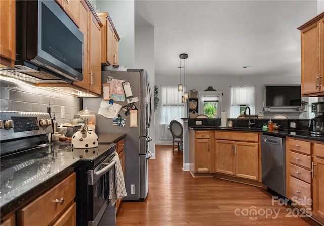 163 Sassafras Rd, Mooresville, NC 28115 - kitchen with appliances with stainless steel finishes, dark wood finished floors, backsplash, a peninsula, and decorative light fixtures