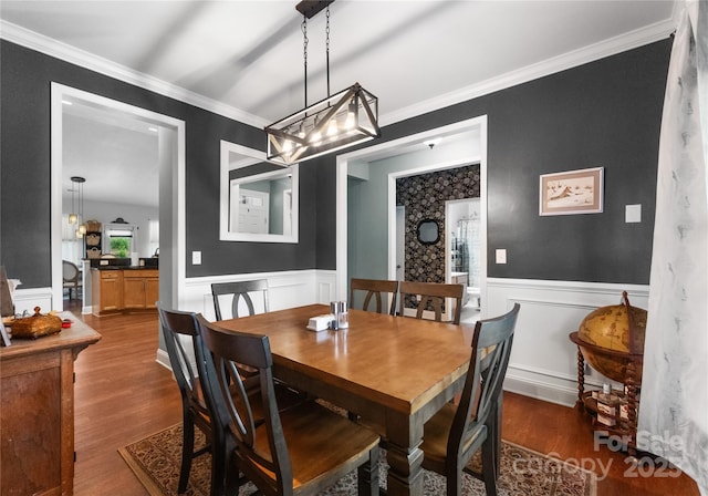 163 Sassafras Rd, Mooresville, NC 28115 - dining space featuring wood finished floors, wainscoting, crown molding, a decorative wall, and a chandelier