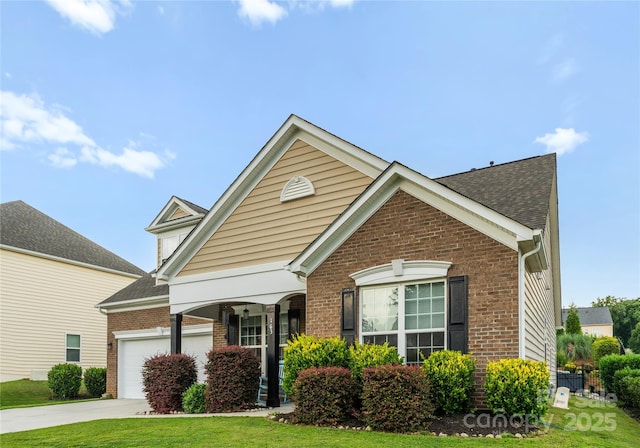163 Sassafras Rd, Mooresville, NC 28115 - traditional-style house featuring brick siding, concrete driveway, an attached garage, and roof with shingles