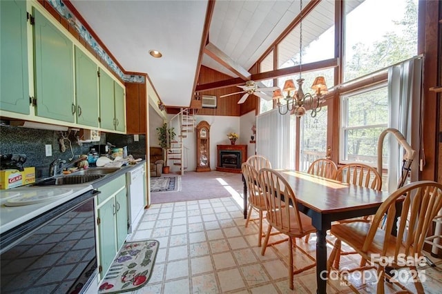 177 Mountain View Ln, Troy, NC 27371 - kitchen featuring green cabinets, high vaulted ceiling, white dishwasher, a fireplace, and a chandelier