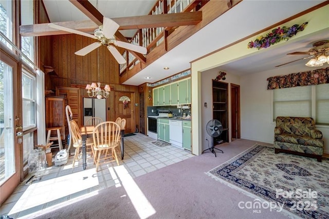 177 Mountain View Ln, Troy, NC 27371 - dining area with a ceiling fan, plenty of natural light, a towering ceiling, wooden walls, and a chandelier