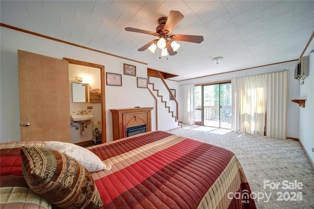 177 Mountain View Ln, Troy, NC 27371 - carpeted bedroom with an AC wall unit, connected bathroom, ornamental molding, a glass covered fireplace, and a ceiling fan