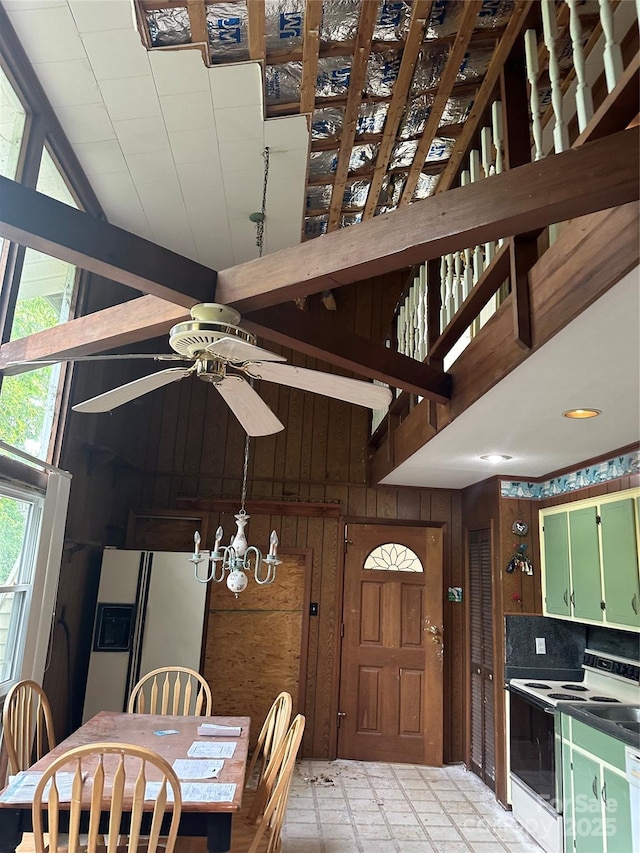 177 Mountain View Ln, Troy, NC 27371 - dining room featuring wooden walls, vaulted ceiling, a chandelier, and ceiling fan