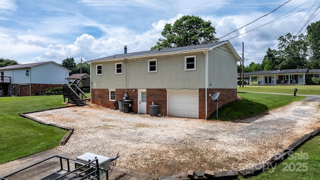 1467 Conway Dr, Granite Falls, NC 28630 - rear view of property with gravel driveway, brick siding, a garage, stairway, and a lawn