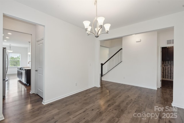 117 Carmine Ct, Troutman, NC 28166 - empty room featuring dark wood-type flooring, stairs, a chandelier, and recessed lighting