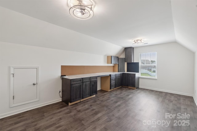 117 Carmine Ct, Troutman, NC 28166 - bonus room featuring vaulted ceiling, dark wood-style floors, and built in study area
