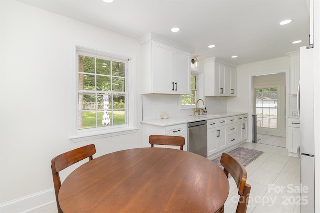 3969 Sheffield Dr, Charlotte, NC 28205 - kitchen with stainless steel appliances, light countertops, healthy amount of natural light, white cabinets, and recessed lighting
