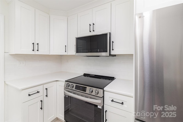 3969 Sheffield Dr, Charlotte, NC 28205 - kitchen with stainless steel appliances, light countertops, tasteful backsplash, and white cabinets