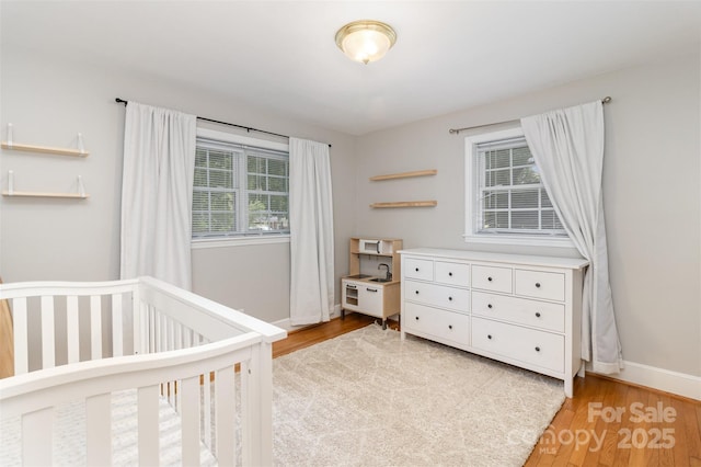3969 Sheffield Dr, Charlotte, NC 28205 - bedroom with light wood-style flooring and a crib