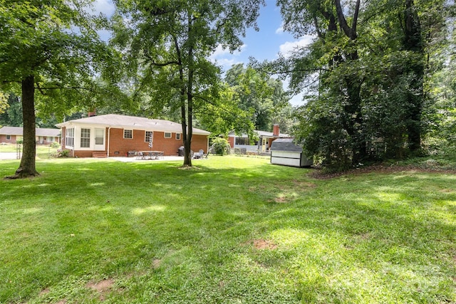 3969 Sheffield Dr, Charlotte, NC 28205 - view of grassy yard with a patio and a storage shed