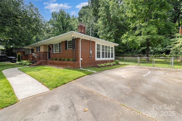 3969 Sheffield Dr, Charlotte, NC 28205 - view of front facade with brick siding, a chimney, and view of wooded area
