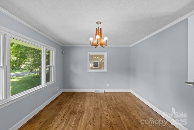 2000 Townsend Ave, Charlotte, NC 28205 - unfurnished dining area with dark wood-style flooring, a chandelier, a textured ceiling, and ornamental molding