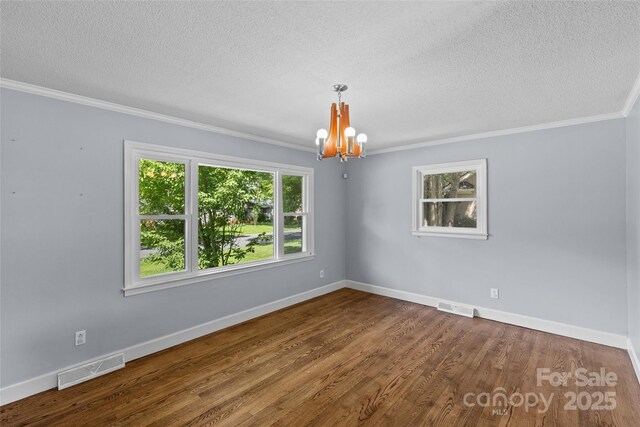 2000 Townsend Ave, Charlotte, NC 28205 - empty room featuring a textured ceiling, a chandelier, ornamental molding, and wood finished floors