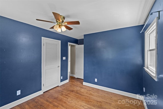2000 Townsend Ave, Charlotte, NC 28205 - unfurnished bedroom featuring wood finished floors, a ceiling fan, and a closet