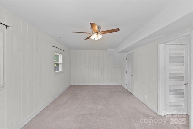 2000 Townsend Ave, Charlotte, NC 28205 - unfurnished bedroom with light carpet, a ceiling fan, and wooden walls