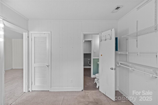 2000 Townsend Ave, Charlotte, NC 28205 - unfurnished bedroom featuring carpet, ornamental molding, a closet, and wooden walls