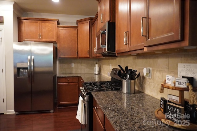 4003 Northerly Island Ct, Gastonia, NC 28056 - kitchen featuring appliances with stainless steel finishes, dark stone countertops, brown cabinets, and decorative backsplash