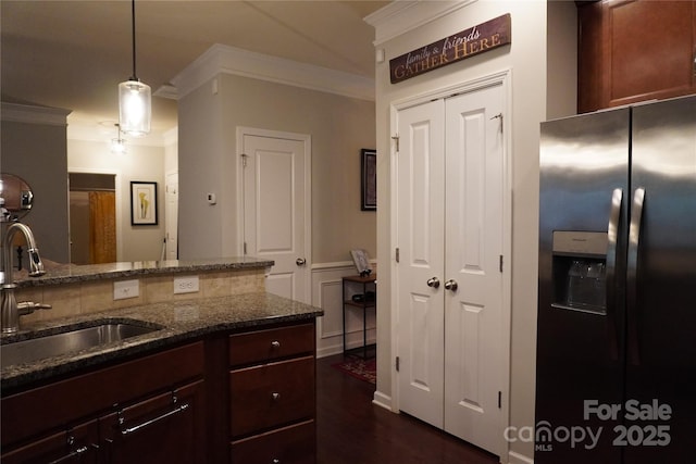 4003 Northerly Island Ct, Gastonia, NC 28056 - kitchen with stainless steel fridge, crown molding, dark stone countertops, hanging light fixtures, and dark wood finished floors