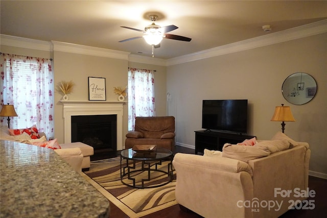 4003 Northerly Island Ct, Gastonia, NC 28056 - living room featuring ceiling fan, ornamental molding, a fireplace, and dark wood-style floors