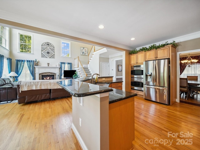 6523 Alba Rose Ln, Huntersville, NC 28078 - kitchen featuring appliances with stainless steel finishes, light wood finished floors, a chandelier, plenty of natural light, and recessed lighting