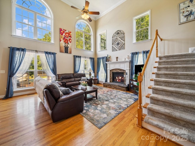 6523 Alba Rose Ln, Huntersville, NC 28078 - living area featuring healthy amount of natural light, stairs, a ceiling fan, ornamental molding, and wood finished floors