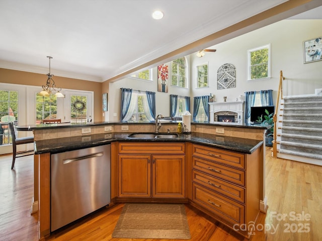 6523 Alba Rose Ln, Huntersville, NC 28078 - kitchen featuring stainless steel dishwasher, open floor plan, dark stone countertops, brown cabinetry, and ornamental molding