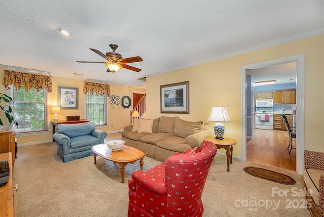 13416 Kintyre Ct, Matthews, NC 28105 - carpeted living area with crown molding, ceiling fan, and stairway