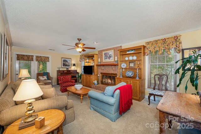13416 Kintyre Ct, Matthews, NC 28105 - living room featuring light carpet, ornamental molding, a ceiling fan, a fireplace, and a textured ceiling