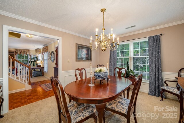 13416 Kintyre Ct, Matthews, NC 28105 - dining room featuring a chandelier, crown molding, wainscoting, stairway, and a textured ceiling