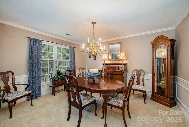13416 Kintyre Ct, Matthews, NC 28105 - dining room featuring a chandelier, light carpet, ornamental molding, a wainscoted wall, and a textured ceiling