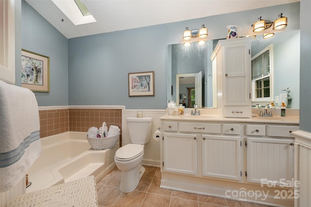 13416 Kintyre Ct, Matthews, NC 28105 - full bathroom featuring a skylight, a garden tub, double vanity, and tile patterned flooring