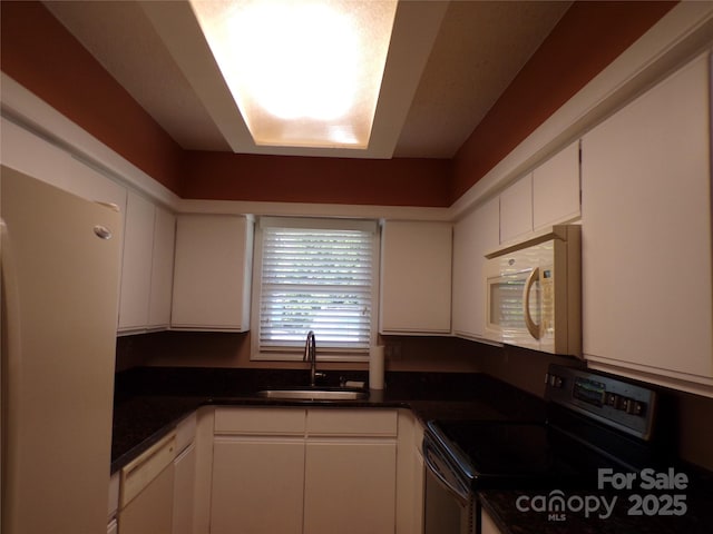 833 21st Ave NE Unit 833, Hickory, NC 28601 - kitchen featuring white microwave, electric range, dark countertops, and white cabinetry